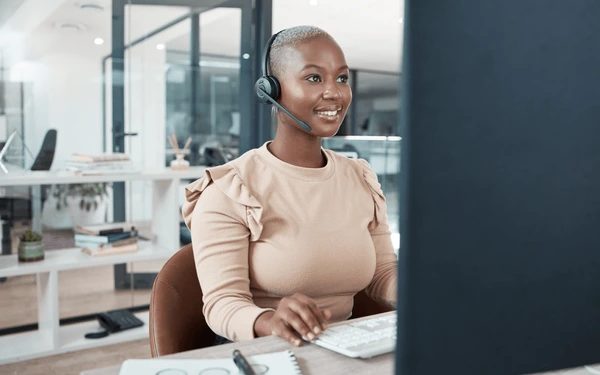 Call centre agent wearing a headset at a desk